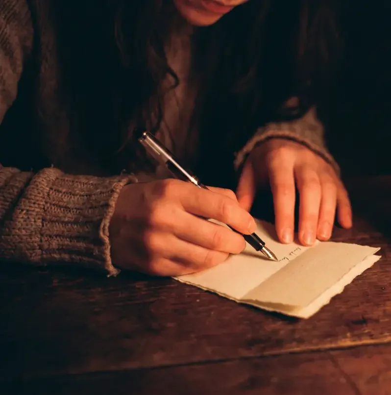 A couple sitting together with notes and a notebook, having a calm conversation